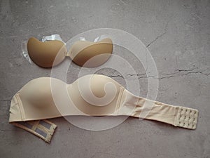 strapless bra on a concrete gray background close-up