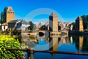 Strasbourg, France. Barrage Vauban scenic river and architecture view on bridge Ponts Couverts with flowers