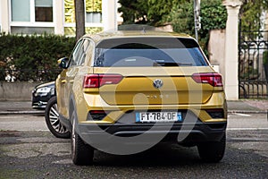 Rear view of orange Volkswagen T-ROC SUV parked in the street