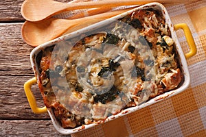 Strata casserole with spinach, cheese and bread close up. horizontal top view photo