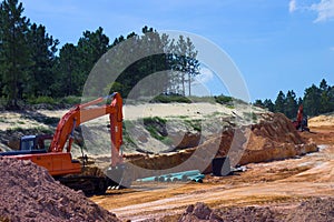 Strata of rock and dirt with heavy equipment photo