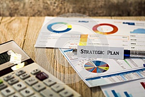 Strategic Plan Investment business finance concept with charts and graphs on wooden board