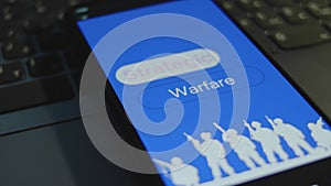 Strategic Warfare inscription on smartphone screen with blue background. Graphic presentation with silhouettes of