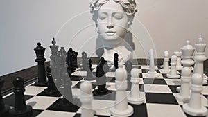 Strategy game Chess and ancient greek statue head