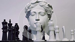 Strategy game Chess and ancient greek statue head