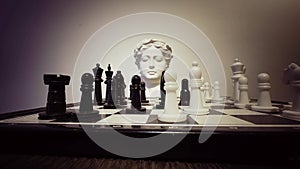 Strategy game Chess and ancient greek statue head