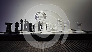 Strategy game Chess and ancient greek statue head