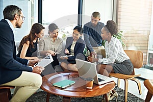 Strategy session in progress. a group of businesspeople discussing work during a meeting.