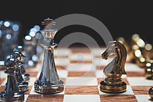 Strategy of strong leadership as king and weak leadership as horse facing each other in wooden chess board. Business marketing of