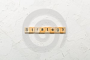 STRATEGY word written on wood block. STRATEGY text on cement table for your desing, concept