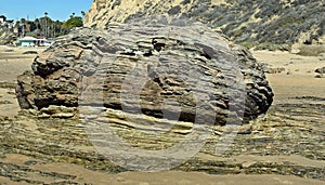 Stratified boulder on shoreline at Crystal Cove State Park, Southern California.