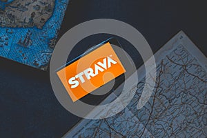 Strava application on the phone on a dark background with map.