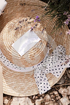 straw accessories,luxurious straw hat and bag lying on the groung in lavender field