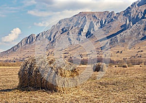 Straw bales on the field and mountain ridges