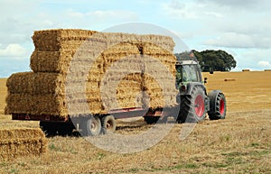 Straw bales, tractor and trailer.