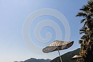 Straw beach umbrella against the sky