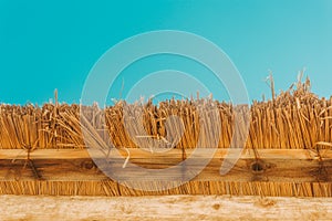 Straw beach umbrella with blue sky