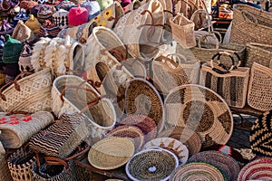 Straw decorative bags and accessories for sale in a market in a souk in the Medina around the Jemaa el-Fnaa square in