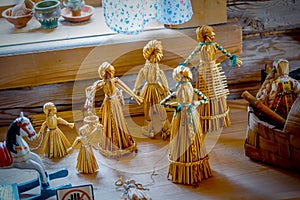 Straw doll. Vintage children`s toys handmade from dried straw