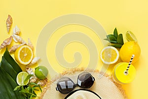 Straw foman`s hat, sun glasses and beach accessory with detox citrics water on yellow. Top view. Flat lay. Copy space.