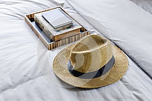 Straw hat on bed