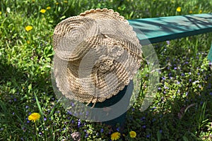 Straw hat on a bench.