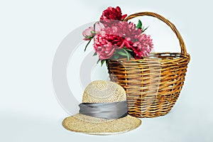 Straw hat with a bouquet of luxurious pink peonies