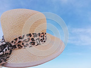 Straw hat in the foreground and the sky in the background