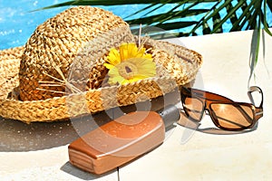 Straw hat, glasses and suntan lotion photo