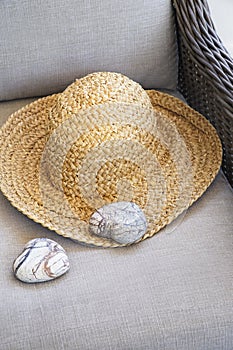 Straw hat with heart shaped rocks on chair