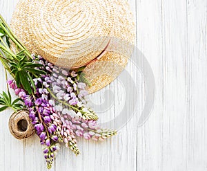Straw hat and lupine flowers