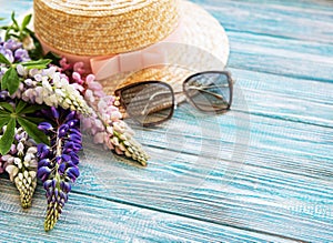 Straw hat and lupine flowers
