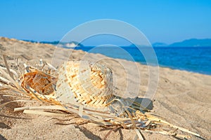Straw hat lying on the tropical seaside