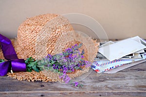 straw hat, old photographs, home archive, letter, bouquet of purple wildflowers on old wooden table, nostalgia, past love, bunch