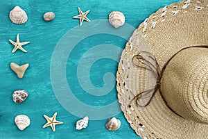 Straw hat, seashells, stones and starfish