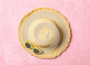 Straw hat and sunglasses on color background, space for text and top view. Summer vacation