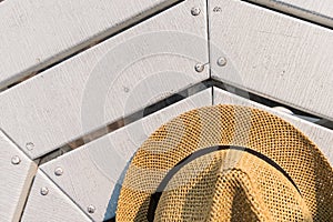 Straw hat on table near the beach. Top view