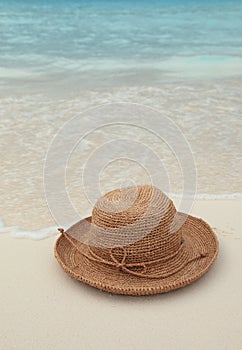 Straw hat on tropical island photo