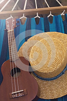 Straw hat and ukulele on a hammock