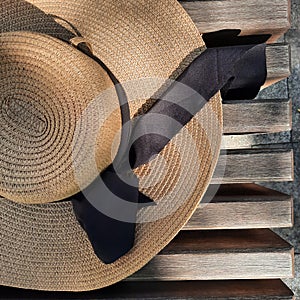 Straw hat on a bench somewhere in the city