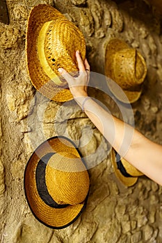 Straw hats hanging on the wall of an old retro-style house reminiscent of times gone by.