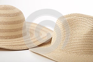 Straw hats overlapped on white background