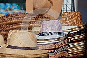 Straw hats for sale on a market stall photo