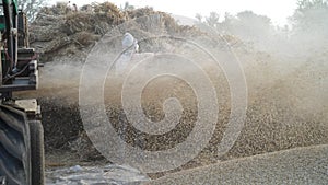 Straw or Husk storm closeup. Blowing husk straw in air from thresher machine