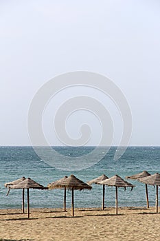 Straw parasols on beach