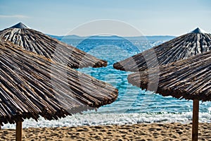 Straw parasols on a beach in Sithonia