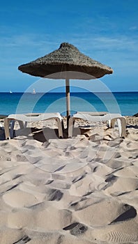 Straw parasols with two loungers