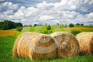 Straw roll on a green field with a beautiful sky