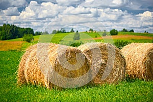 Straw roll on a green field with a beautiful sky