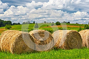 Straw roll on a green field with a beautiful sky